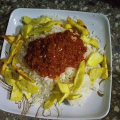 A picture of Rice and stew with fried sweet potatoes.