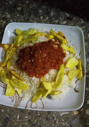 A picture of Rice and stew with fried sweet potatoes.