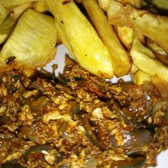 A picture of Fried sweet potato with onion and egg sauce.