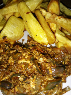 A picture of Fried sweet potato with onion and egg sauce.
