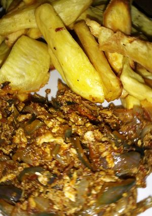 A picture of Fried sweet potato with onion and egg sauce.