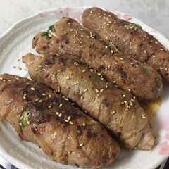 A picture of Rolled meat, veggies and cheese.