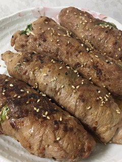 A picture of Rolled meat, veggies and cheese.