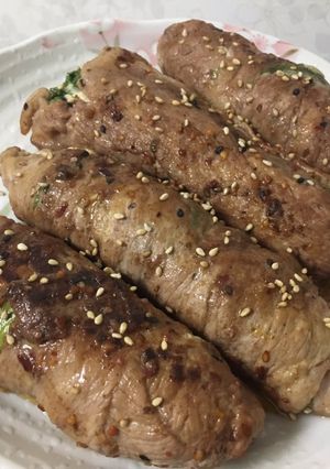 A picture of Rolled meat, veggies and cheese.