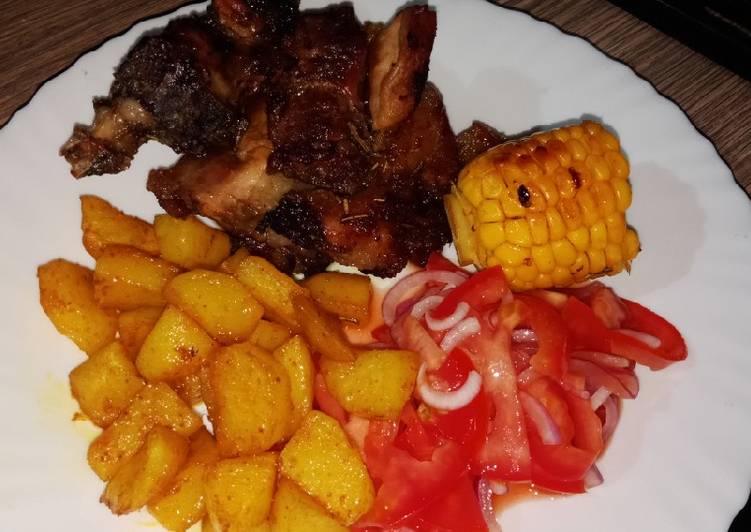 Oven baked pork with roasted potatoes and sweet corn