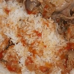 A picture of Yummy Matumbo Stew w/ rice or Ugali accompaniment.