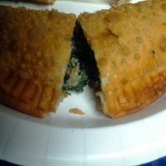 A picture of spinach and cheese empanada.