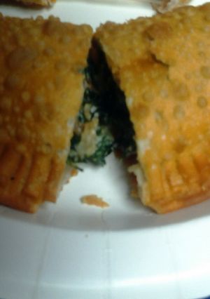 A picture of spinach and cheese empanada.