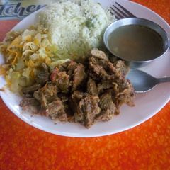 A picture of Vegetable rice with fried beef and steamed cabbage.