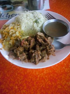 A picture of Vegetable rice with fried beef and steamed cabbage.