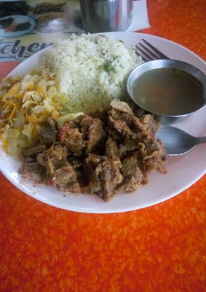 A picture of Vegetable rice with fried beef and steamed cabbage.