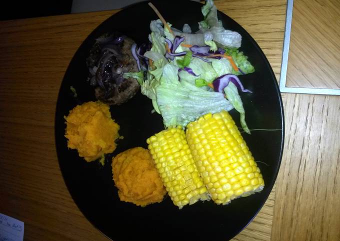 venison burger topped with sweet onions with aside of sweet potato mash with sweet corn