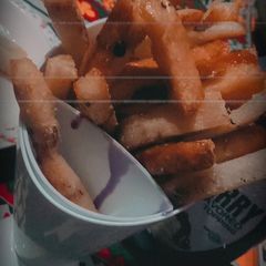 A picture of Bread fries with blue berry sauce.