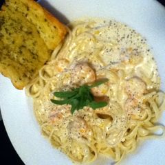 A picture of Shrimp in a Blue Cheese Sauce over Pasta.