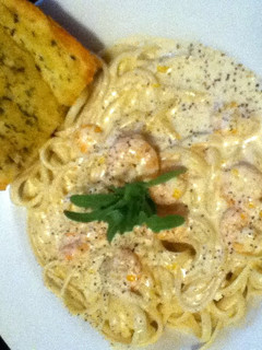A picture of Shrimp in a Blue Cheese Sauce over Pasta.