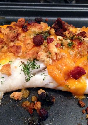 A picture of Baked cod with crispy chorizo and cheese topping.