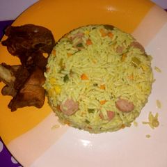 A picture of Fried rice with fried chicken.