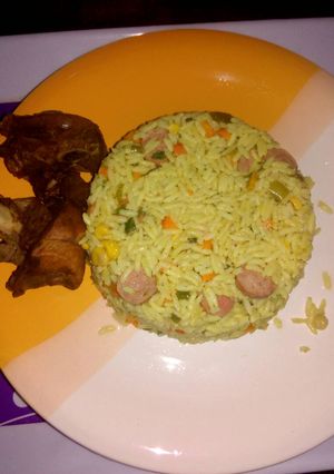 A picture of Fried rice with fried chicken.