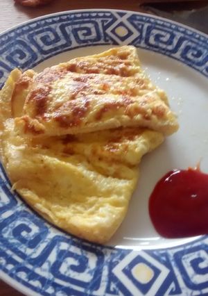 A picture of 3 egg and cheese omelette.