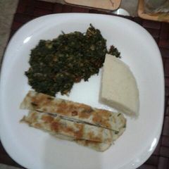 A picture of Ugali omelette and fried kale.