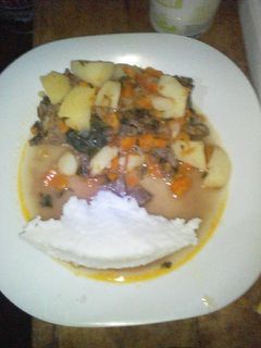 A picture of Fried beef served with ugali.