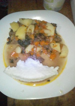 A picture of Fried beef served with ugali.