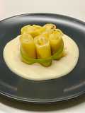 Paccheri ripieni di crema di patate e baccalà, su fonduta dì parmigiano