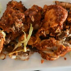 A picture of Peppered chicken with cabbage and lemon.