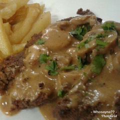A picture of Whosayna’s Pepper Steak topped with Mushroom Sauce.
