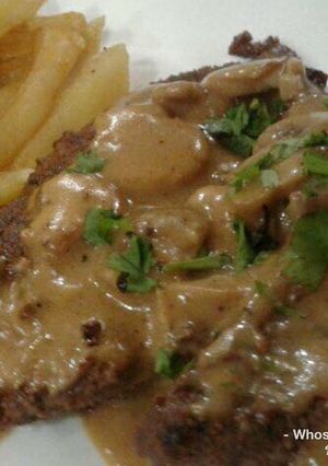 A picture of Whosayna’s Pepper Steak topped with Mushroom Sauce.
