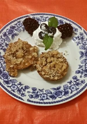 A picture of Caramel Vodka Apple Tartlets with a Pecan Strusel Topping.