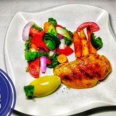 A picture of Grilled Chicken and Salad with honey braised baby carrots.