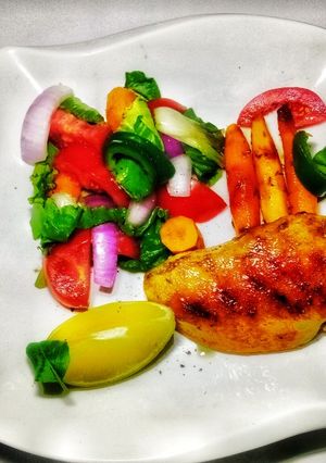 A picture of Grilled Chicken and Salad with honey braised baby carrots.