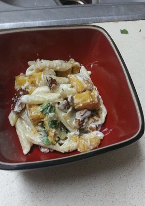 A picture of Penne with butternut squash and goat cheese.