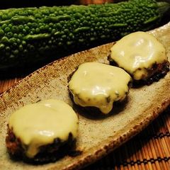A picture of Bitter Melon Hamburgers Topped with Melted Cheese.