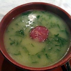 A picture of kale soup with chorizo (portuguese caldo verde).