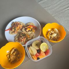 A picture of Chicken and Pepper Tortillas with Fried Egg and Fruit Salad.