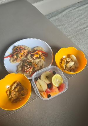 A picture of Chicken and Pepper Tortillas with Fried Egg and Fruit Salad.