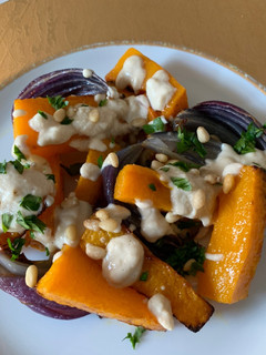 A picture of Roasted Butternut Squash and Red Onions with Tahini sauce.