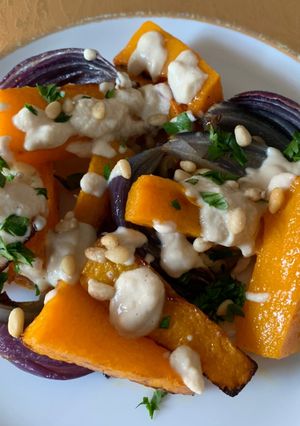 A picture of Roasted Butternut Squash and Red Onions with Tahini sauce.