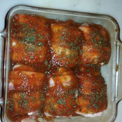 A picture of Bacon wrapped bbq chicken thighs.