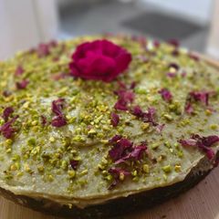 A picture of Almond walnut cake with mascarpone pistachio cream frosting.
