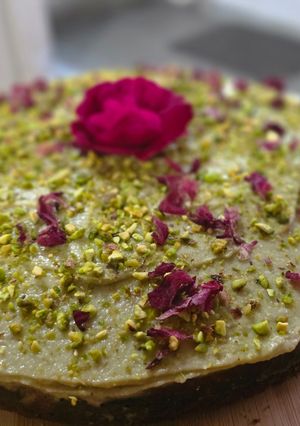 A picture of Almond walnut cake with mascarpone pistachio cream frosting.