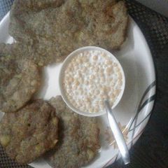 A picture of Finger millet puris with boondi raita.