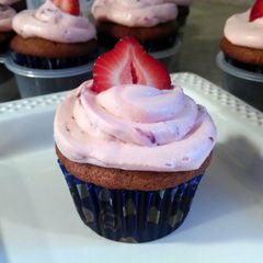 A picture of Banana Cupcakes with Strawberry Frosting.