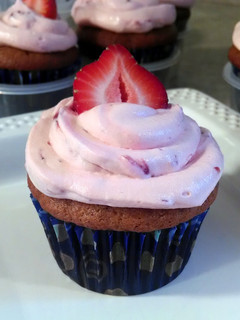 A picture of Banana Cupcakes with Strawberry Frosting.