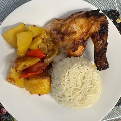 A picture of Chicken with rice and vegetables.