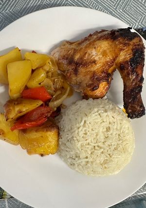 A picture of Chicken with rice and vegetables.