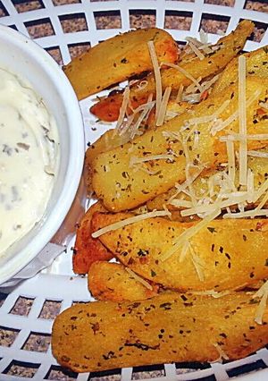 A picture of Garlic Herb Parmesan fries &* Pesto Garlic Aioli*.