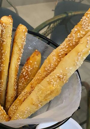 A picture of Cheesy bread sticks with hot and sour chicken soup.
